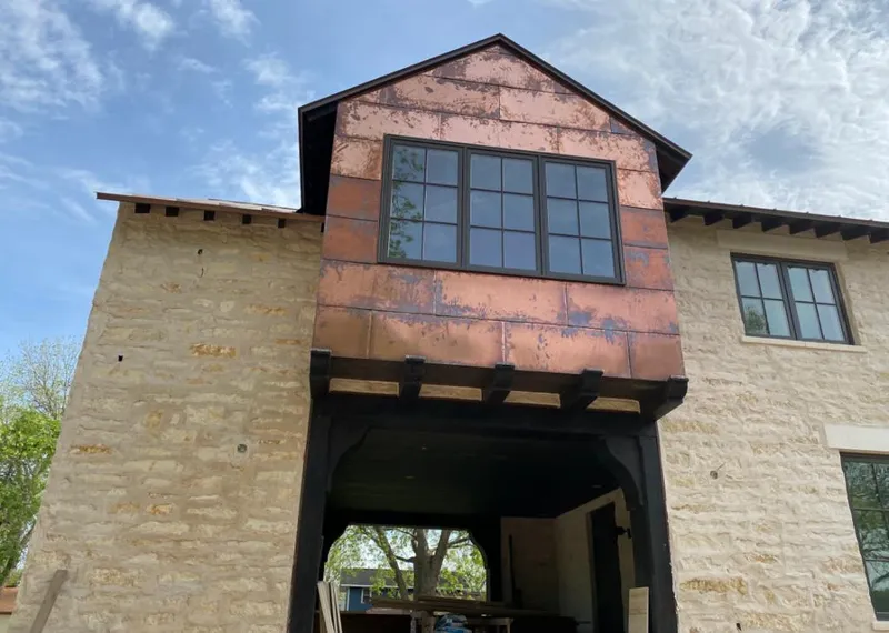 Copper metal panel facade on a stone building for Skylight Installation in Harvey